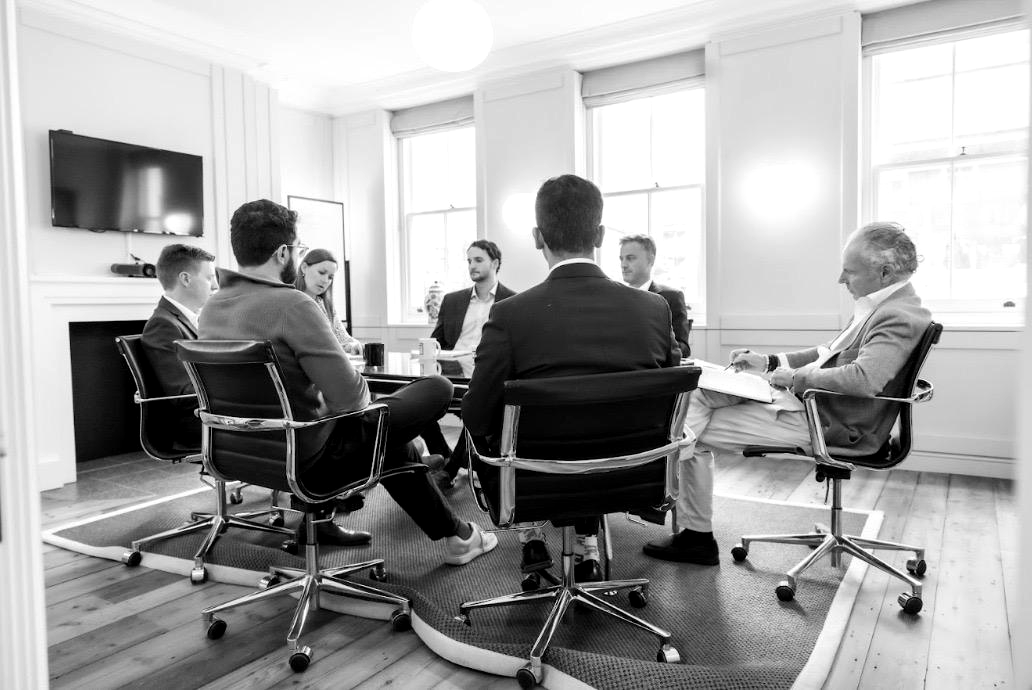 A small group in conversation around a table